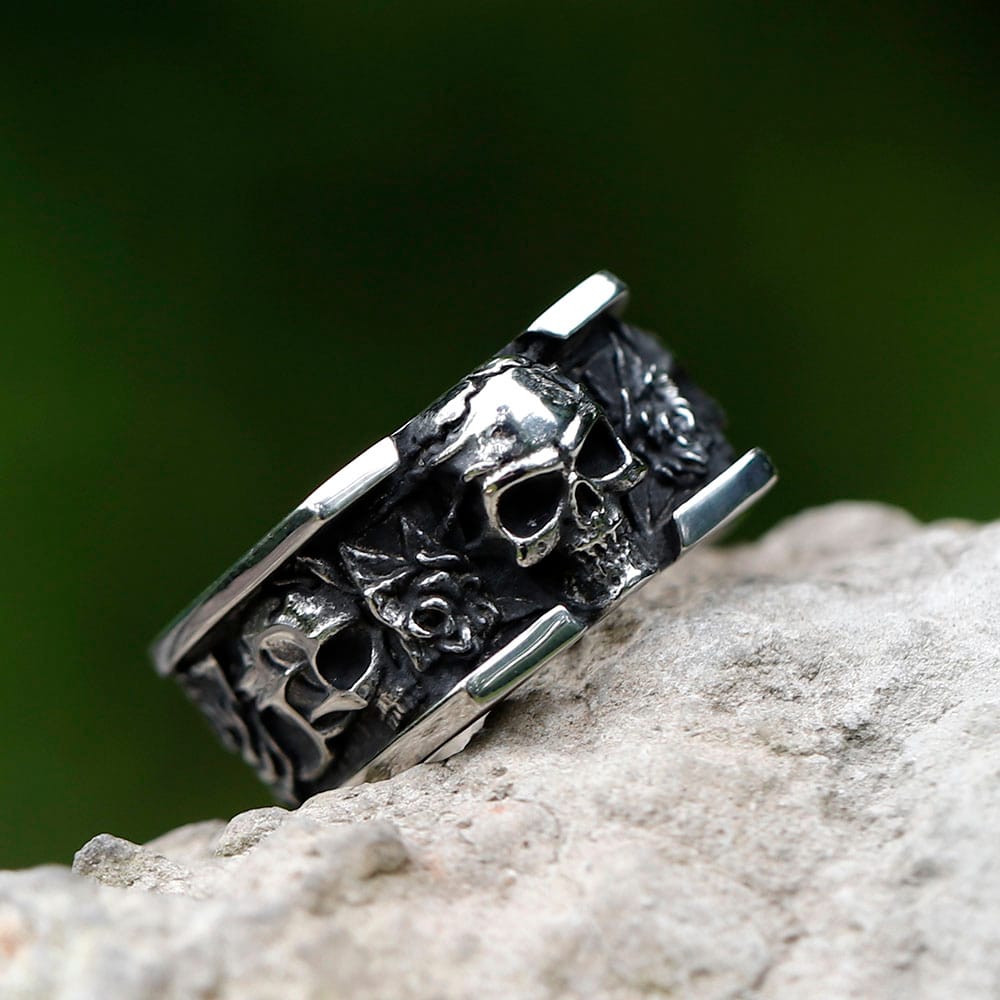Detailed view of the side engraving, including a rose and abstract pattern, on the right side of the stainless steel skull ring band.