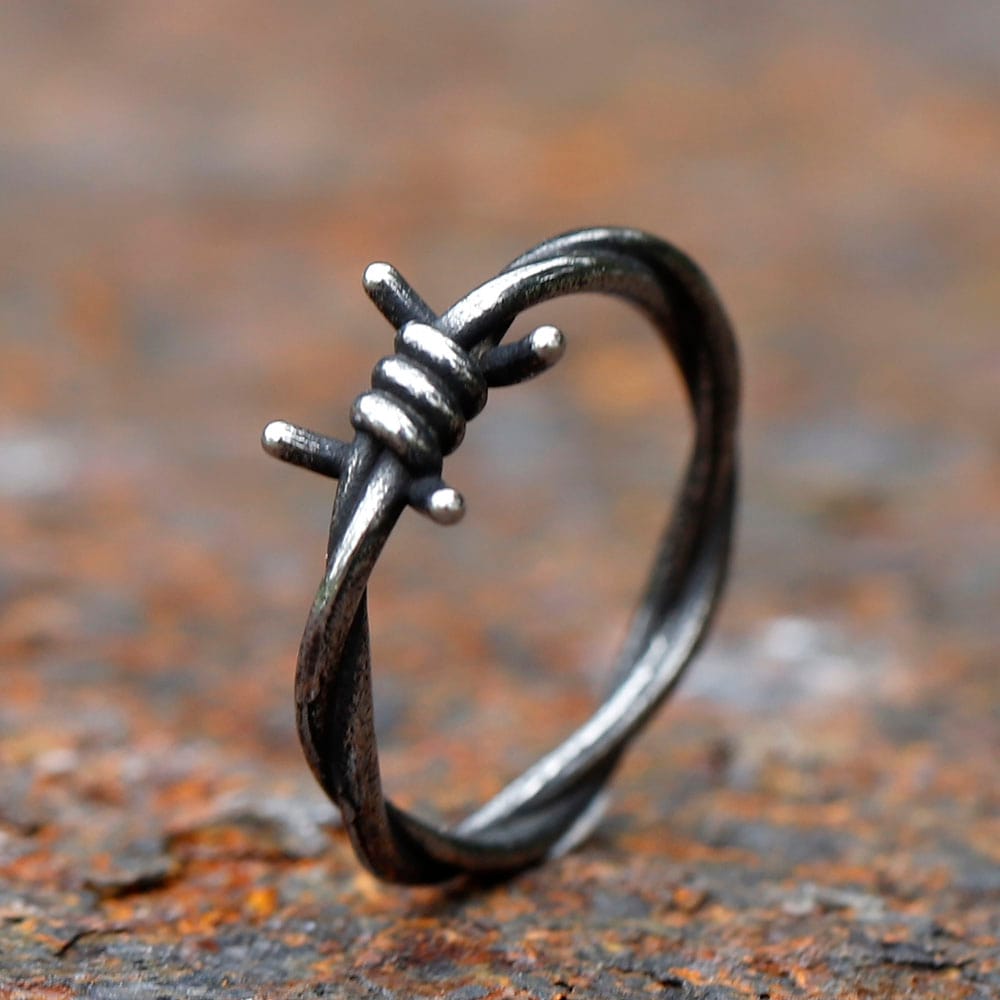 Angled view of a unisex gothic barbed wire ring made from durable stainless steel.