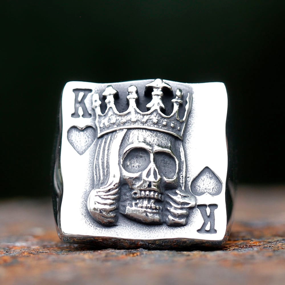 Front view of King of cards skull ring in stainless steel with carved crown and playing card details