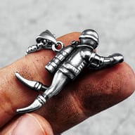 Angled shot of the stainless steel scuba diver pendant, showcasing texture.