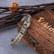 Two-tone stainless steel Viking Thor's hammer cuff bracelet resting against a rustic wooden box