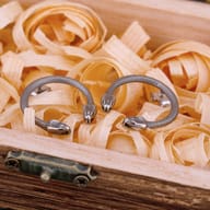 Close-up of the detailed scales and two snake heads of one stainless steel stud earring.