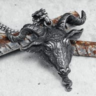 Detailed view of the ram goat pendant's sculpted horns and forehead design.