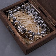 Side profile displaying the articulated vertebrae links in silver and gold tone