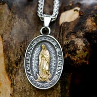 Detailed close up of Virgin Mary medallion in antiqued steel