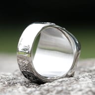 Detailed view of the ring's side pattern, showcasing the continuous flow of the design around the band.