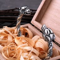 Stainless steel Viking goat head cuff bracelet resting inside a wooden gift box
