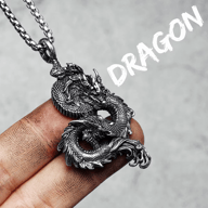 Flying Dragon 316L stainless steel pendant necklace, held on a finger