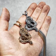 Close-up of the dragon pendant's head and detailed scales in 316L stainless steel