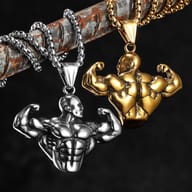 Detailed view of the bodybuilder pendant's bicep and chest musculature, with faint 'MUSCLE MAN' text in background