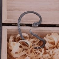 Side profile of serpent ear wrap highlighting the realistic snake scale design