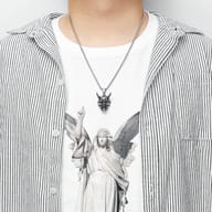 Right profile of the Hannya mask pendant, emphasizing its horns and facial contours.