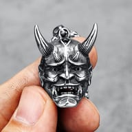 Side detail of the 316L steel Hannya mask pendant's horns and textured surface.