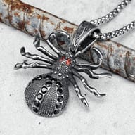 Detailed shot of the 316L stainless steel spider pendant on a finger