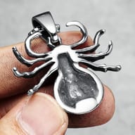 View of spider pendant's abdomen with textured surface and black accents