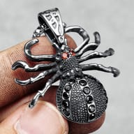 Close-up of the gothic spider pendant's legs and red gem eyes