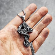 Close-up of the dragon skull cross pendant's top bail and durable stainless steel chain
