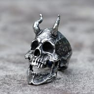 Front three-quarter view of horned demon skull ring in 316L stainless steel