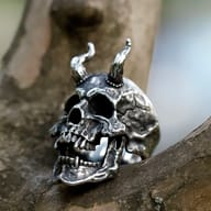 Close-up detail of textured horns and open jaw on gothic skull ring