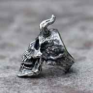 Side profile highlighting the deep carved bone texture of devil skull ring