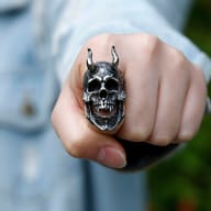 Men's horned skull ring worn on hand showcasing bold biker proportions