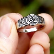 Angled shot of the heavy-duty stainless steel ring, showcasing its polished edges and symbolic details.