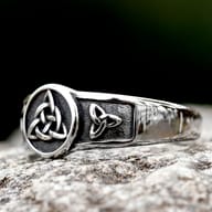 Stainless steel Celtic knot ring worn on a finger, demonstrating its comfortable fit and distinctive style.