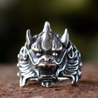 Close-up of the dragon ring's head from a slight angle, showing eye detail.