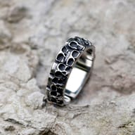 Side view of the men's skull ring highlighting its polished interior and robust design.