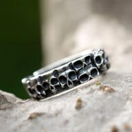 The full 316L stainless steel skull ring displayed on a textured gray background.