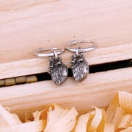Close-up of 316L stainless steel anatomical heart drop charm with detailed texture