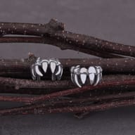 Close-up of the textured fanged design on a 316L stainless steel vampire ear cuff.