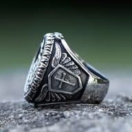 Side profile of men's Saint George ring showing band and shield design