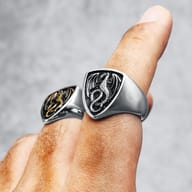 Angled shot of the ring, emphasizing the intricate texture and depth of the dragon shield design.