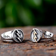 Side profile of stainless steel ring showing etched lightning bolt pattern on the band