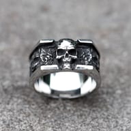 Close-up of the vintage skull design on the men's stainless steel ring, highlighting the detailed forehead and upper jaw from a top-left angle.