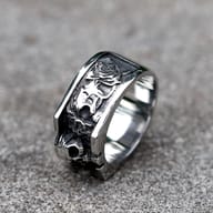 Close-up of the vintage skull design on the men's stainless steel ring, highlighting the detailed forehead and upper jaw from a top-right angle.