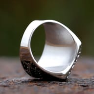 Macro shot of the side filigree and polished edges of the stainless steel signet ring