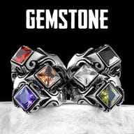Gothic ring on a dark background, emphasizing the polished stainless steel and brilliant purple stone.