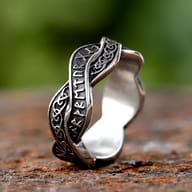 Close-up of the Celtic knot pattern on the interwoven stainless steel ring band.