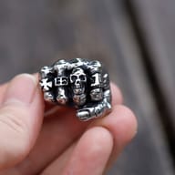 Angled shot of the vintage gothic skull fist ring, highlighting its textured finish.