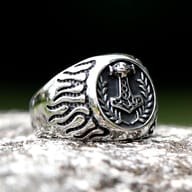 Textured side band of the 316L stainless steel Mjolnir ring with wave-like patterns.