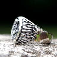 Close-up of the Thor's Hammer (Mjolnir) emblem and the laurel wreath detail on the ring.