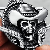 Angled view of the skull cowboy pendant with two revolvers