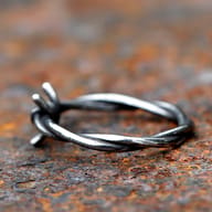 Front view of the unique twisted design of the stainless steel barbed wire ring.