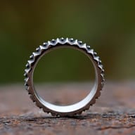 Detailed close-up view of the textured gear teeth on the stainless steel ring.