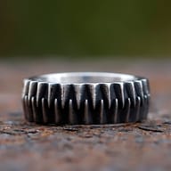 Angled close-up showing the robust relief of the gear teeth on the steel ring.