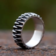 Industrial gear 316L stainless steel ring on a weathered surface.