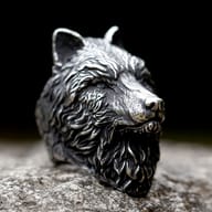Intricate details of the wolf's snout and fur on a stainless steel ring, captured from the front-left.