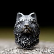 Side profile of the wolf's face, emphasizing the strong jawline and detailed fur on the durable stainless steel ring.